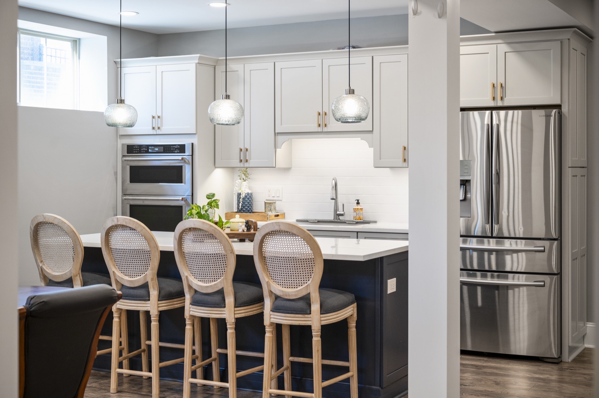 Navy island bar and stainless appliances in the Locust Creek basement