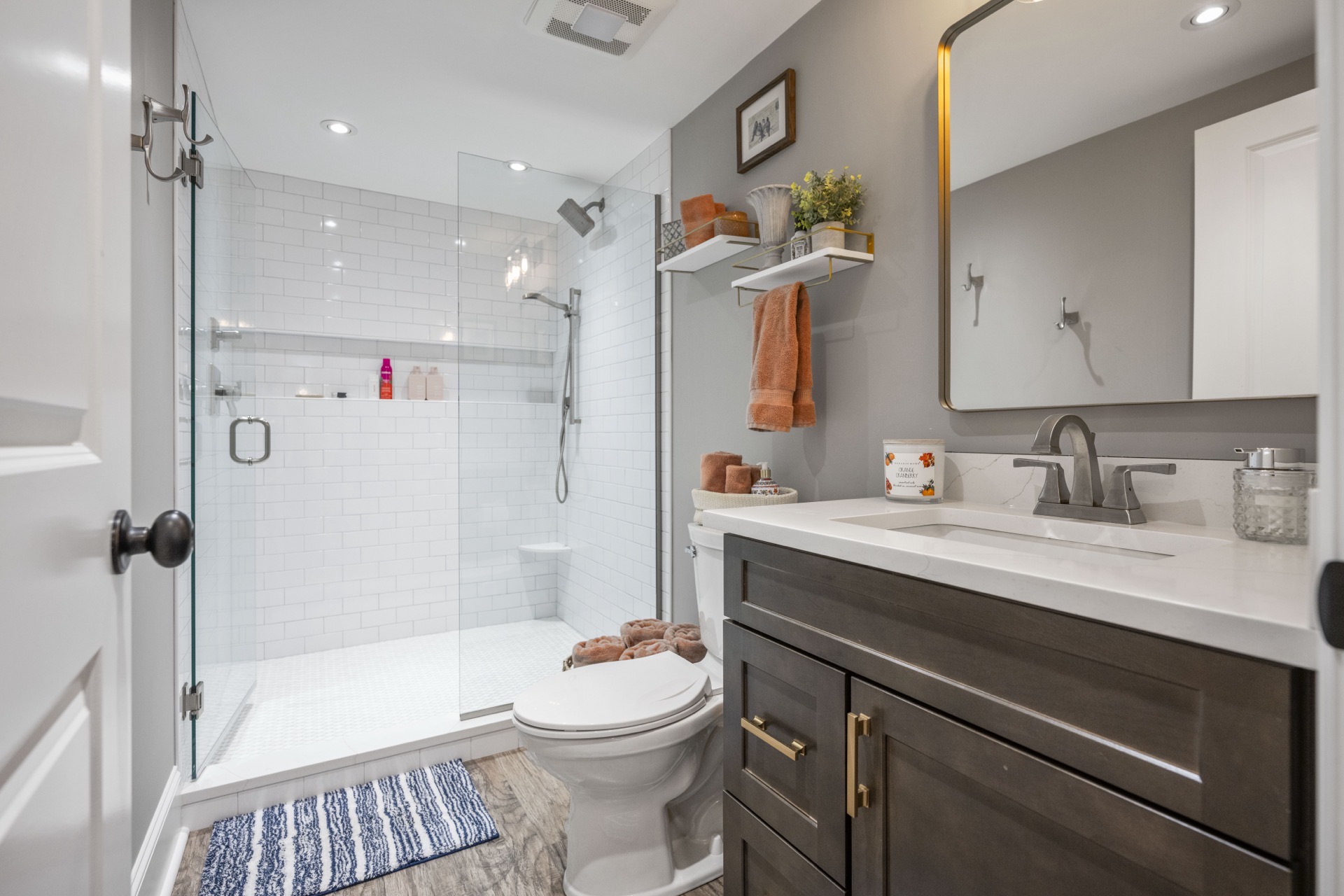 Locust Creek guest bath with dark vanity and glass shower