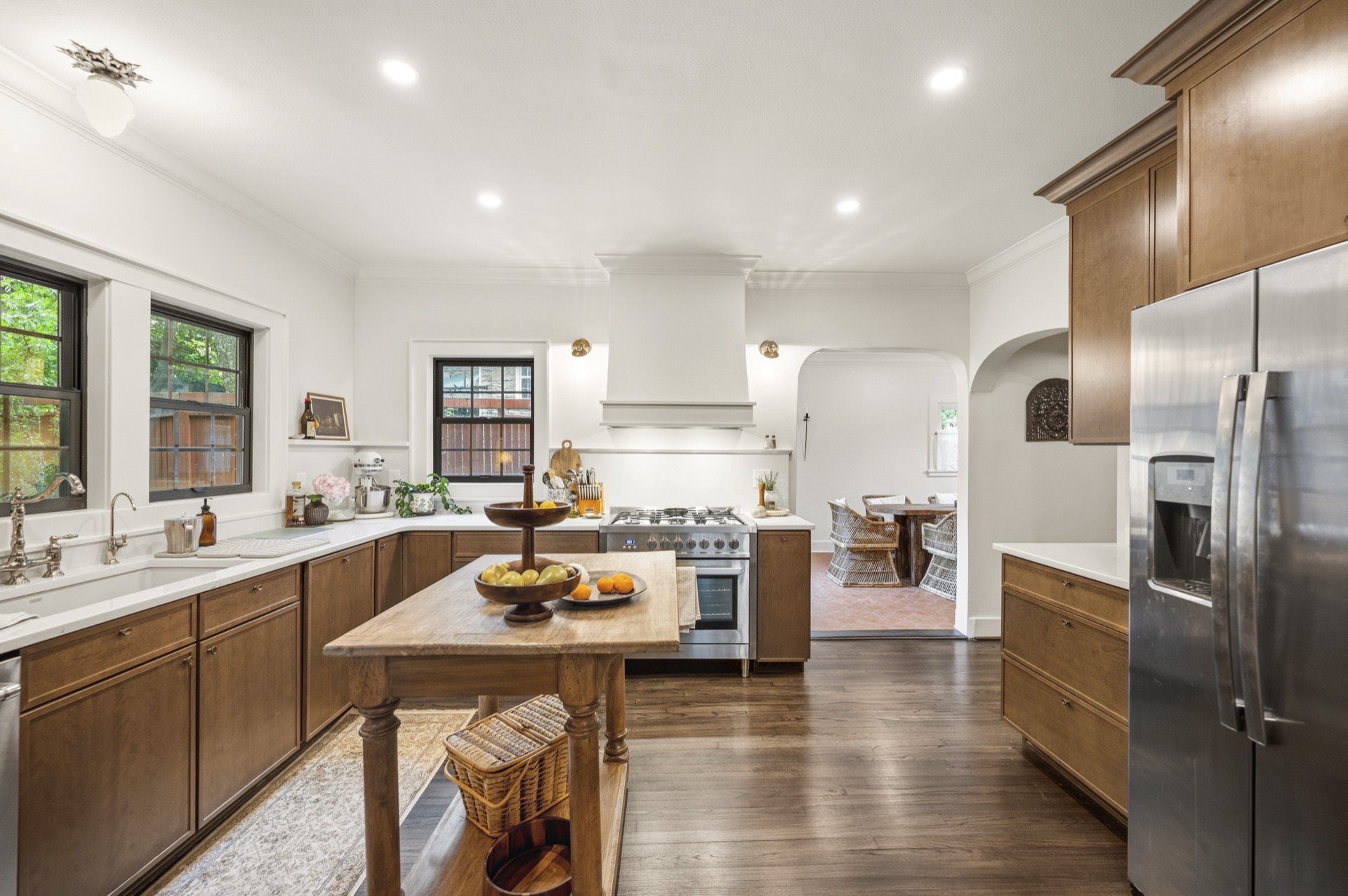 Farmhouse sink, black windows, and a table-style island — kitchen renovation in Lexington, KY
