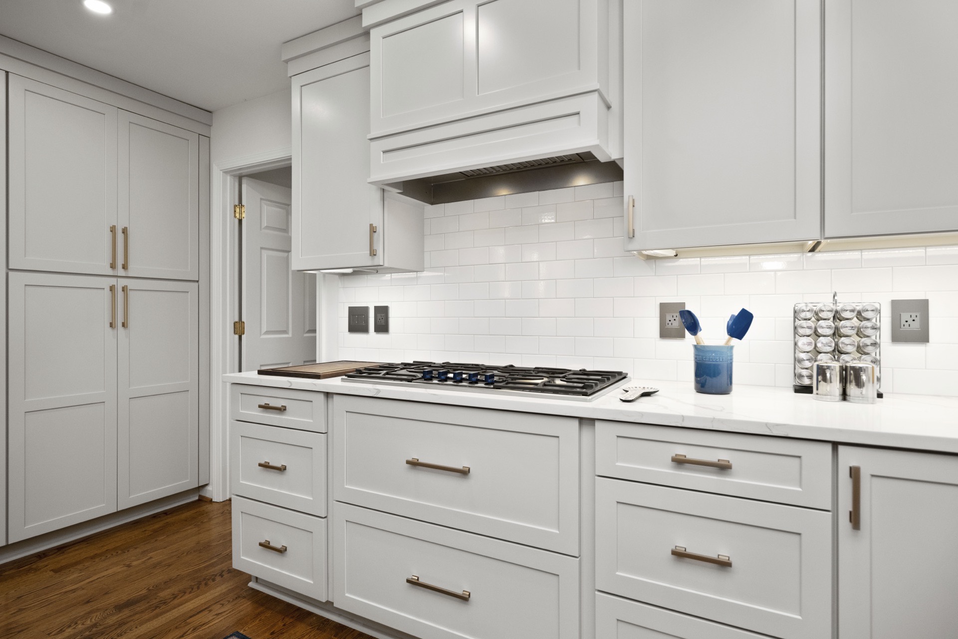 Range wall with subway tile and brass hardware at Saint Andrews