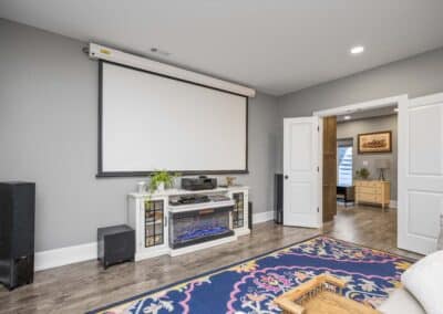 Cozy Retreat Basement Renovation - living area with projector screen